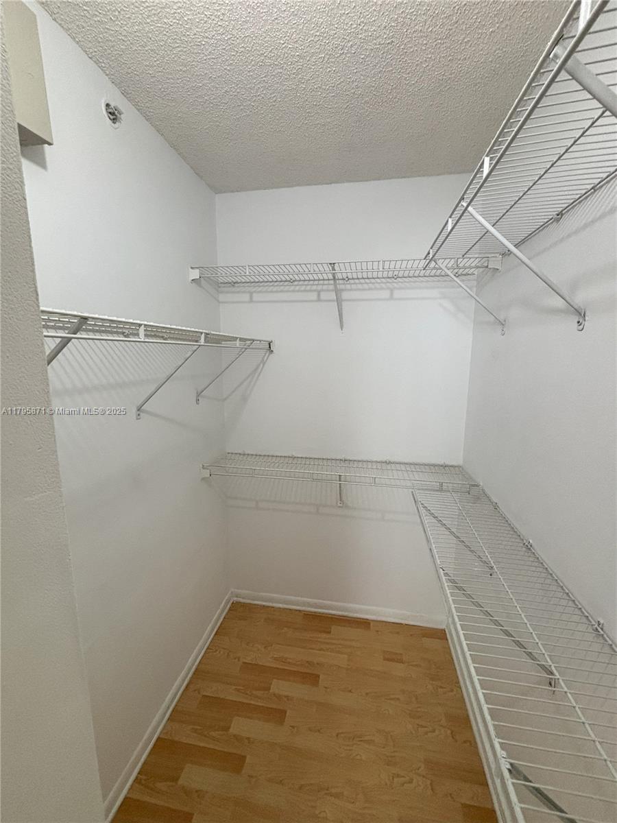 126 Southwest 17th Road, Unit 505 Miami, FL 33129 - Photo 6 of 23 a view of a room with racks on the wall