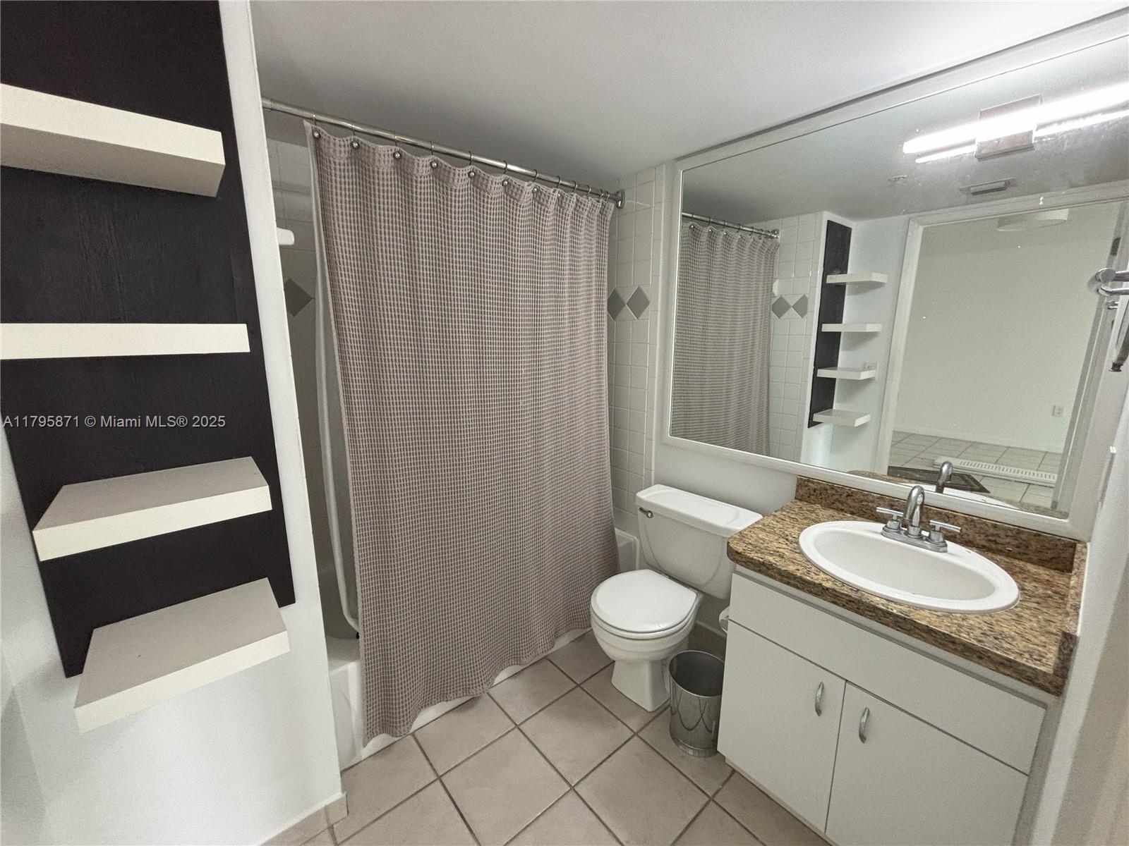 126 Southwest 17th Road, Unit 505 Miami, FL 33129 - Photo 7 of 23 a bathroom with a sink a toilet and a mirror