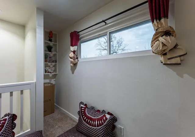 a bedroom with a bed a dresser and a window