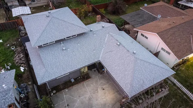 an aerial view of a house with a yard