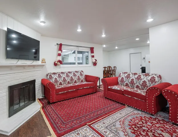 a kitchen with stainless steel appliances kitchen island granite countertop a refrigerator and a sink