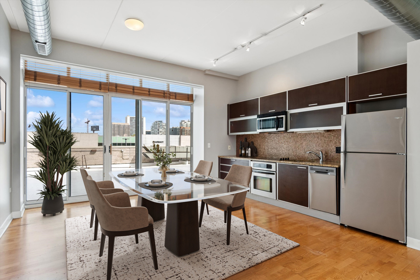 660 West Wayman Street, Unit 501 Chicago, IL 60661 - Photo 5 of 22 a kitchen with a refrigerator a stove and a dining table with wooden floor