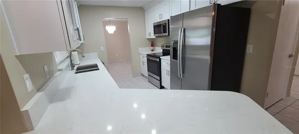a view of a kitchen with a refrigerator