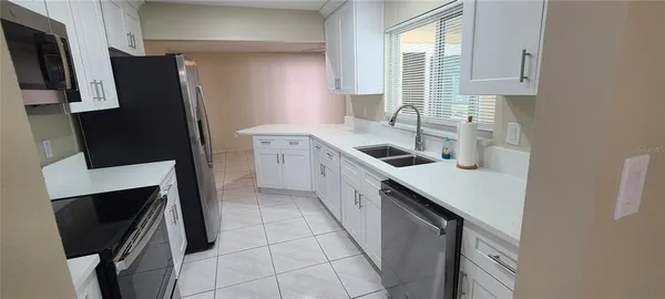 a kitchen with stainless steel appliances a sink stove and refrigerator