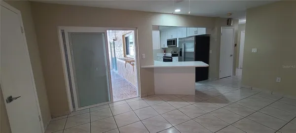 a view of kitchen with furniture and refrigerator