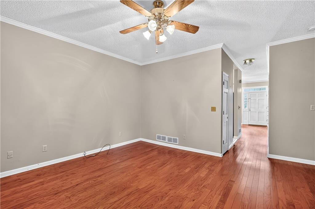 2197 Spring Walk Court Atlanta, GA 30341 - Photo 12 of 31 wooden floor in an empty room with a window