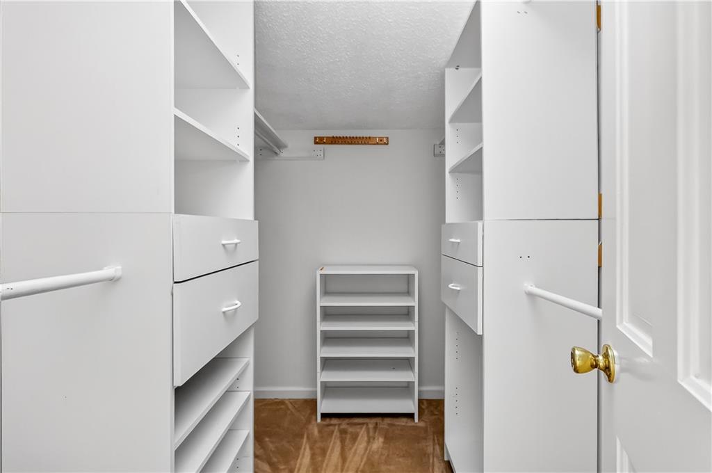2197 Spring Walk Court Atlanta, GA 30341 - Photo 24 of 31 a view of walk in closet with empty racks
