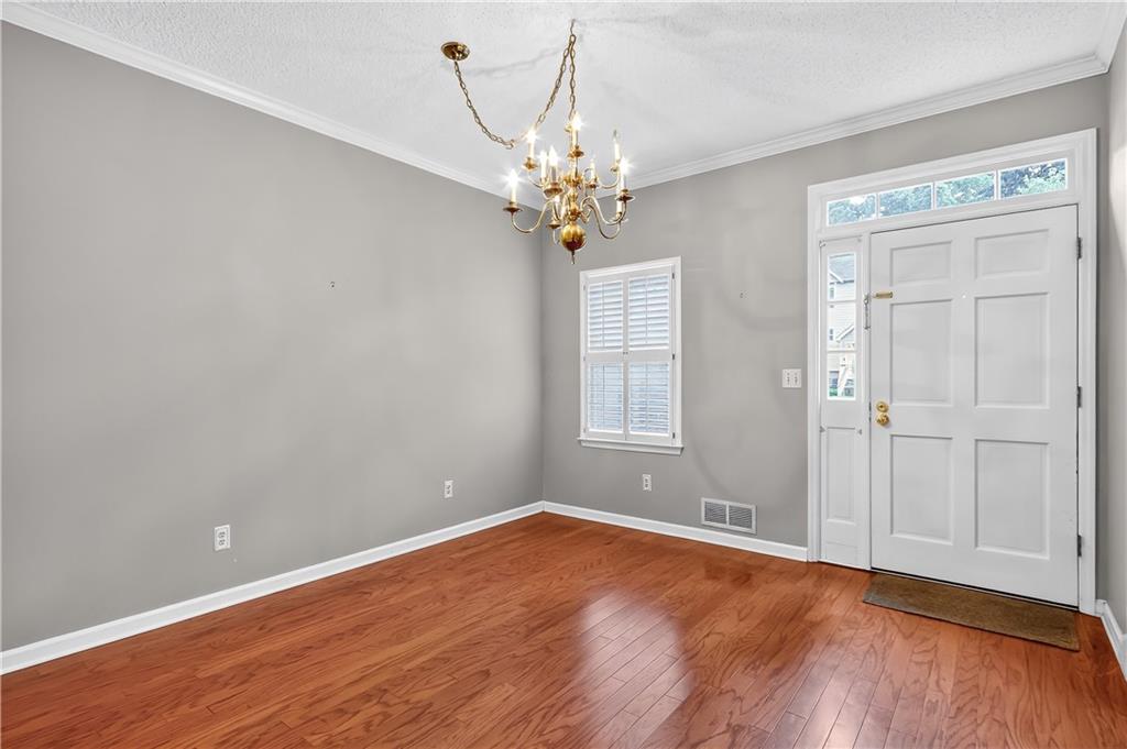 2197 Spring Walk Court Atlanta, GA 30341 - Photo 3 of 31 a view of an empty room with window and wooden floor