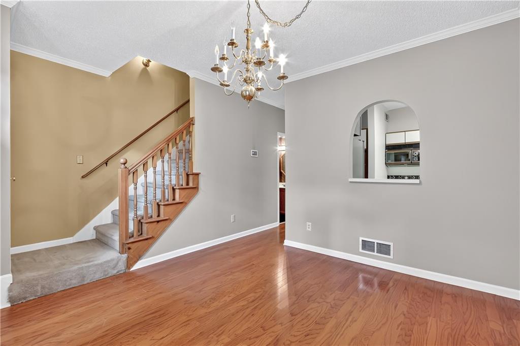 2197 Spring Walk Court Atlanta, GA 30341 - Photo 4 of 31 wooden floor in an entryway with a chandelier