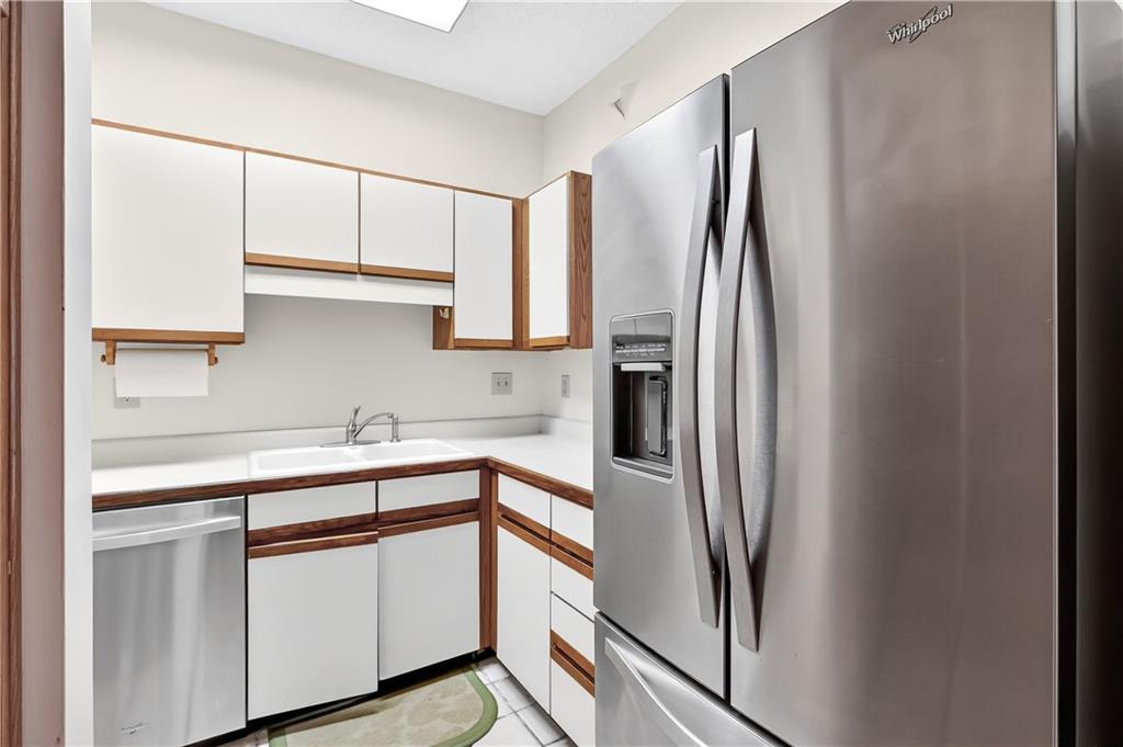 2197 Spring Walk Court Atlanta, GA 30341 - Photo 5 of 31 a kitchen with stainless steel appliances a refrigerator sink and cabinets