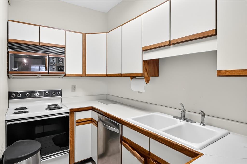 2197 Spring Walk Court Atlanta, GA 30341 - Photo 6 of 31 a kitchen with a sink cabinets and appliances