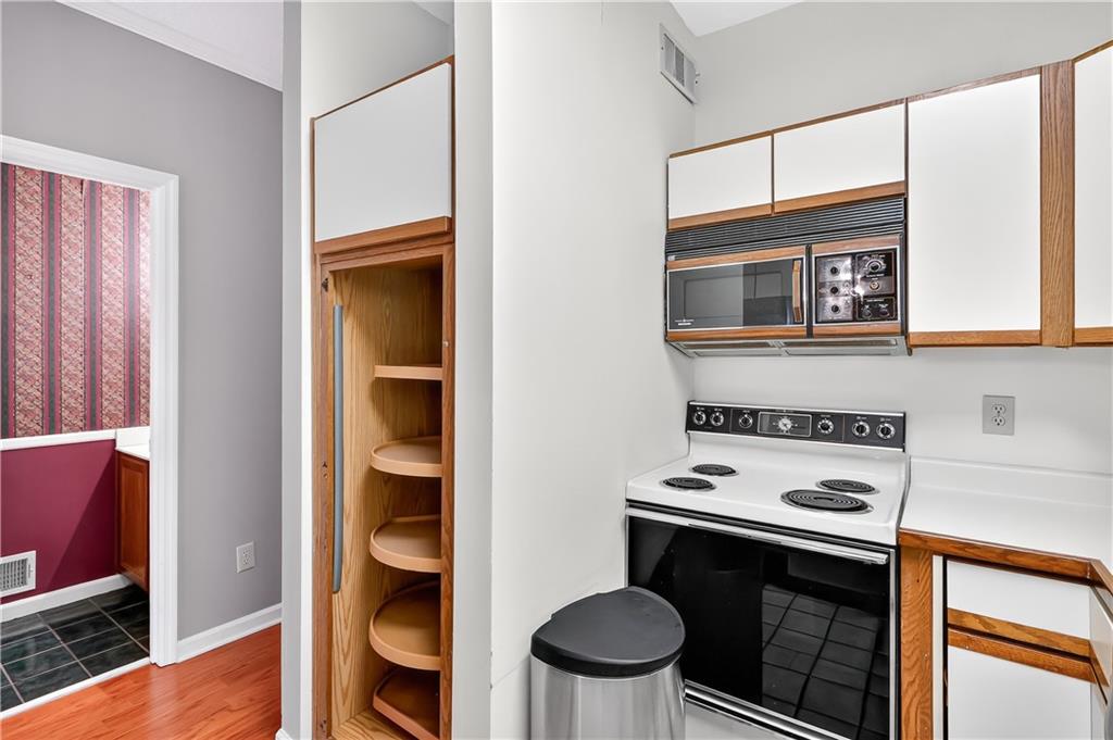 2197 Spring Walk Court Atlanta, GA 30341 - Photo 8 of 31 a kitchen with a stove and a microwave