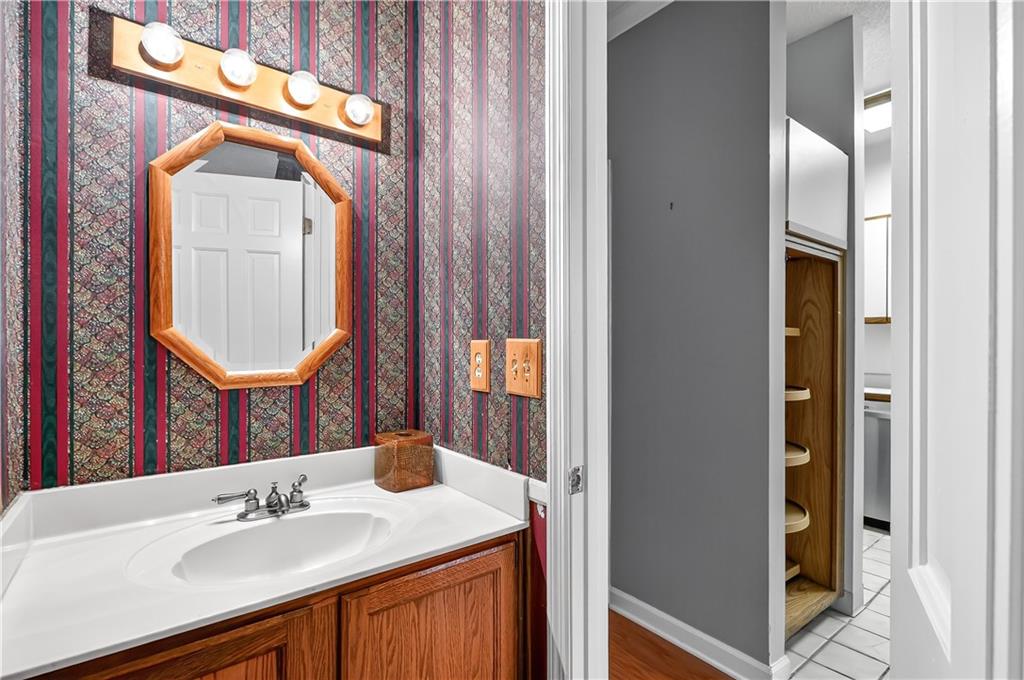 2197 Spring Walk Court Atlanta, GA 30341 - Photo 9 of 31 a bathroom with a sink a mirror and a shower
