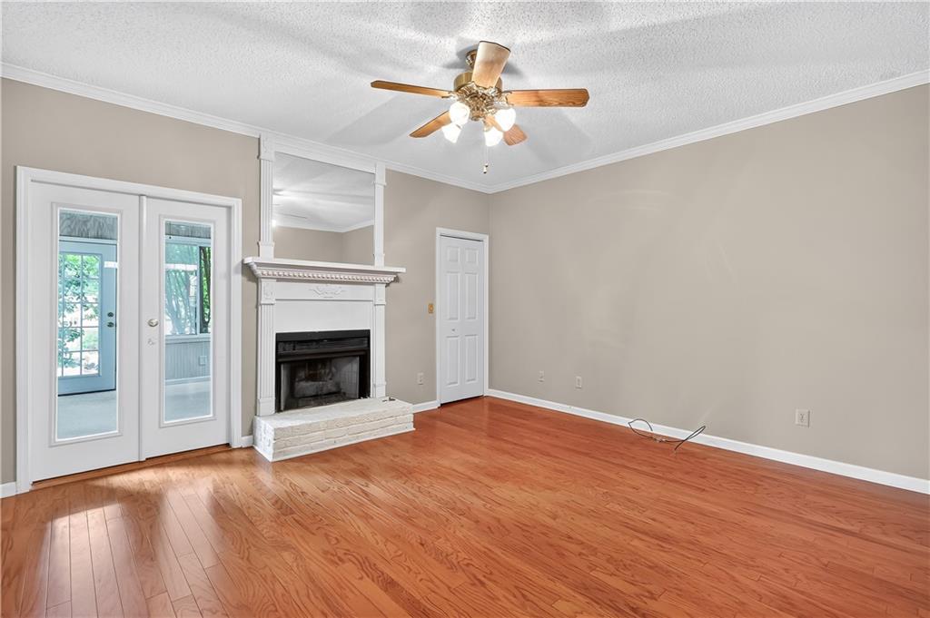 2197 Spring Walk Court Atlanta, GA 30341 - Photo 10 of 31 a view of an empty room with wooden floor and a fireplace