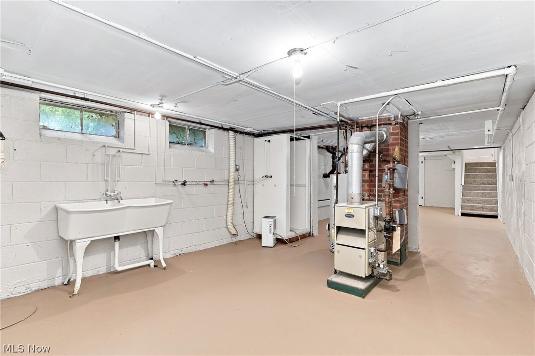 7524 Root Road North Ridgeville, OH 44039 - Photo 37 of 50 Utility room with a large basin sink, painted concrete block walls, and exposed overhead pipes