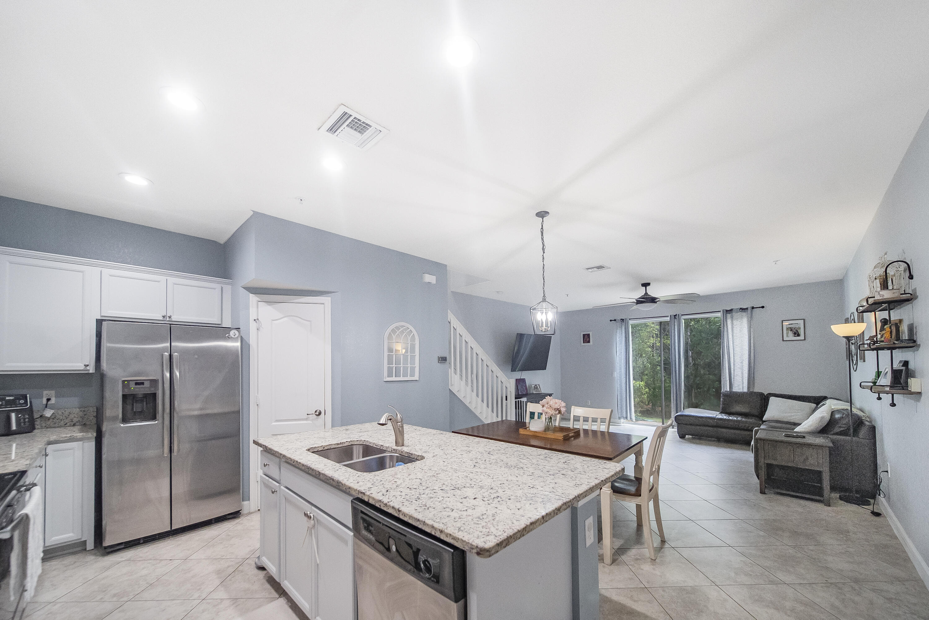 a kitchen with a counter space a sink appliances and cabinets