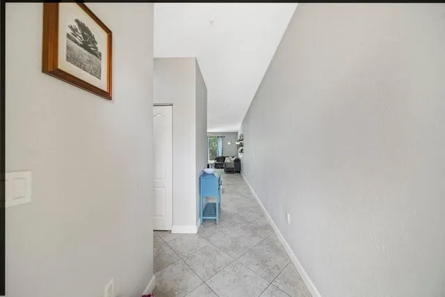 a view of a hallway with wooden shelves