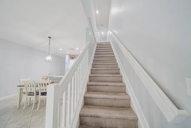 a bed room with a bed and a chandelier