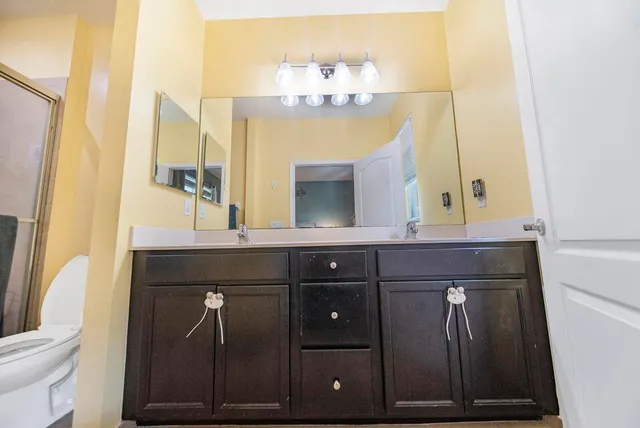 a bathroom with a sink a vanity and a mirror