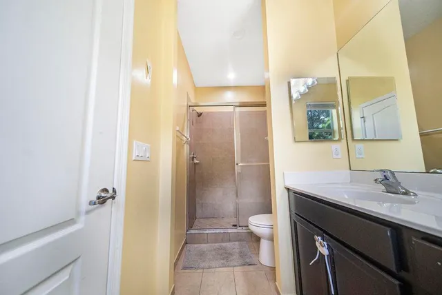 a bathroom with a toilet a sink and mirror