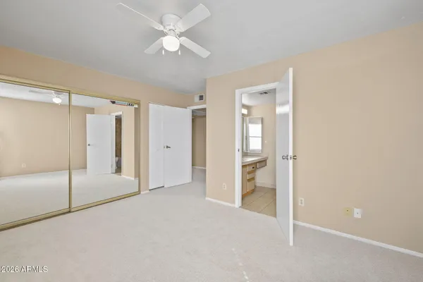 a view of a room with a ceiling fan and a window