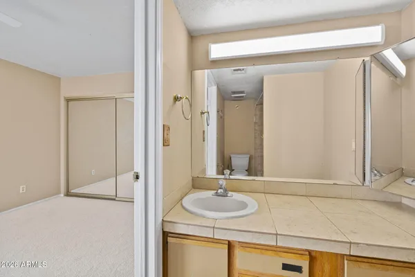 a view of an empty room with a ceiling fan