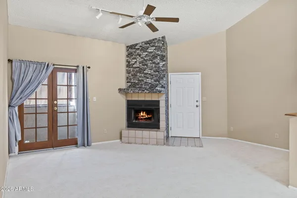 a view of an empty room with a fireplace