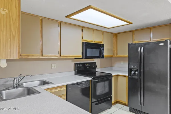 a kitchen with a sink cabinets and stainless steel appliances