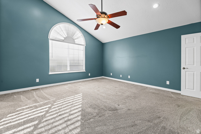 4117 North Wolf Ridge Circle Eden, UT 84310 - Photo 19 of 63 Carpeted room featuring an arched window, vaulted ceiling, ceiling fan, recessed lighting, and a paneled door