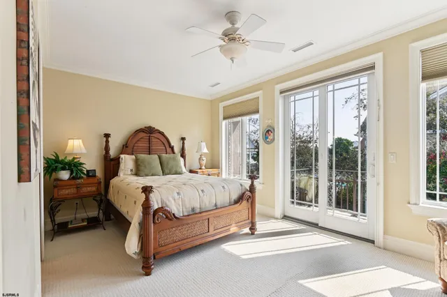 a bed sitting in a spacious bedroom next to a window