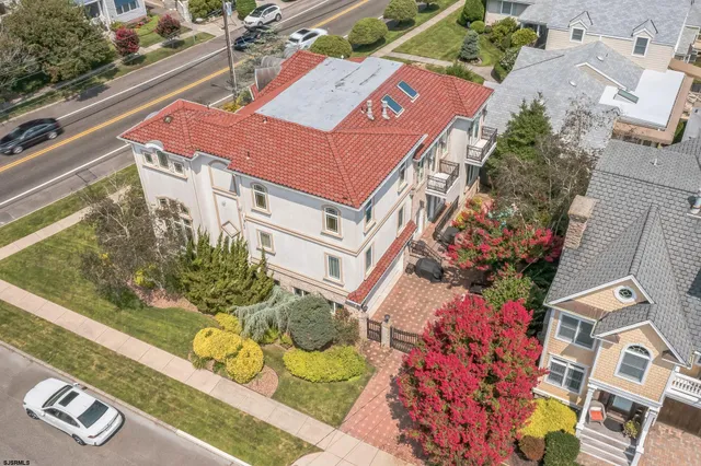 an aerial view of a residential apartment building with a yard