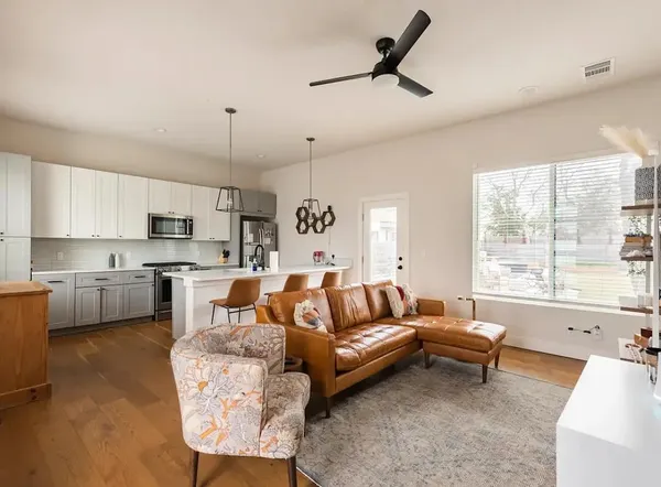 a living room with furniture and a large window