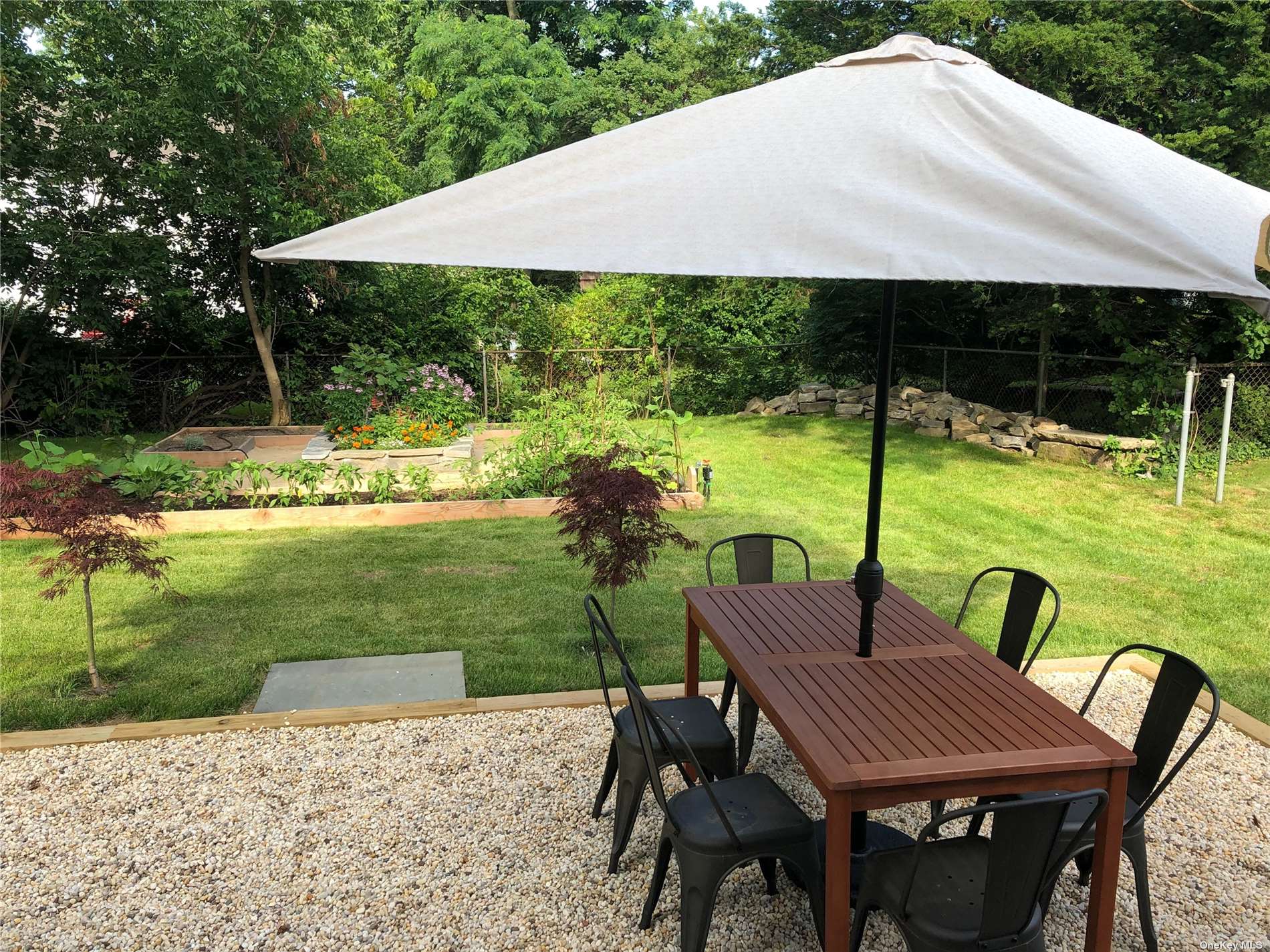 412 Greenport, undefined 00000 - Photo 7 of 18 a view of an chairs and table in the garden