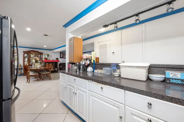 a kitchen with sink cabinets and living room view