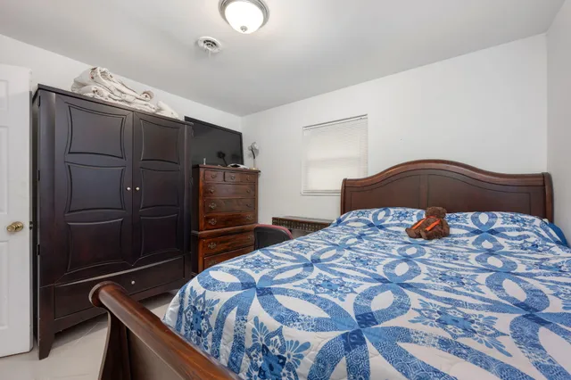 a bedroom with a bed and a television