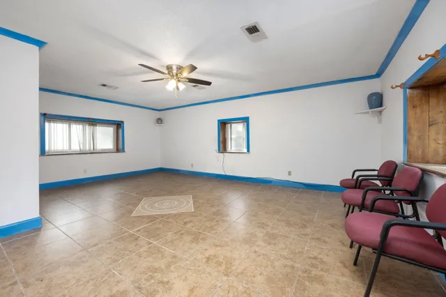 a view of room with lounge chair and windows
