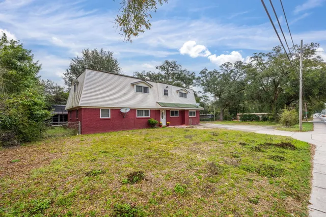 a view of a house with a yard patio and fire pit