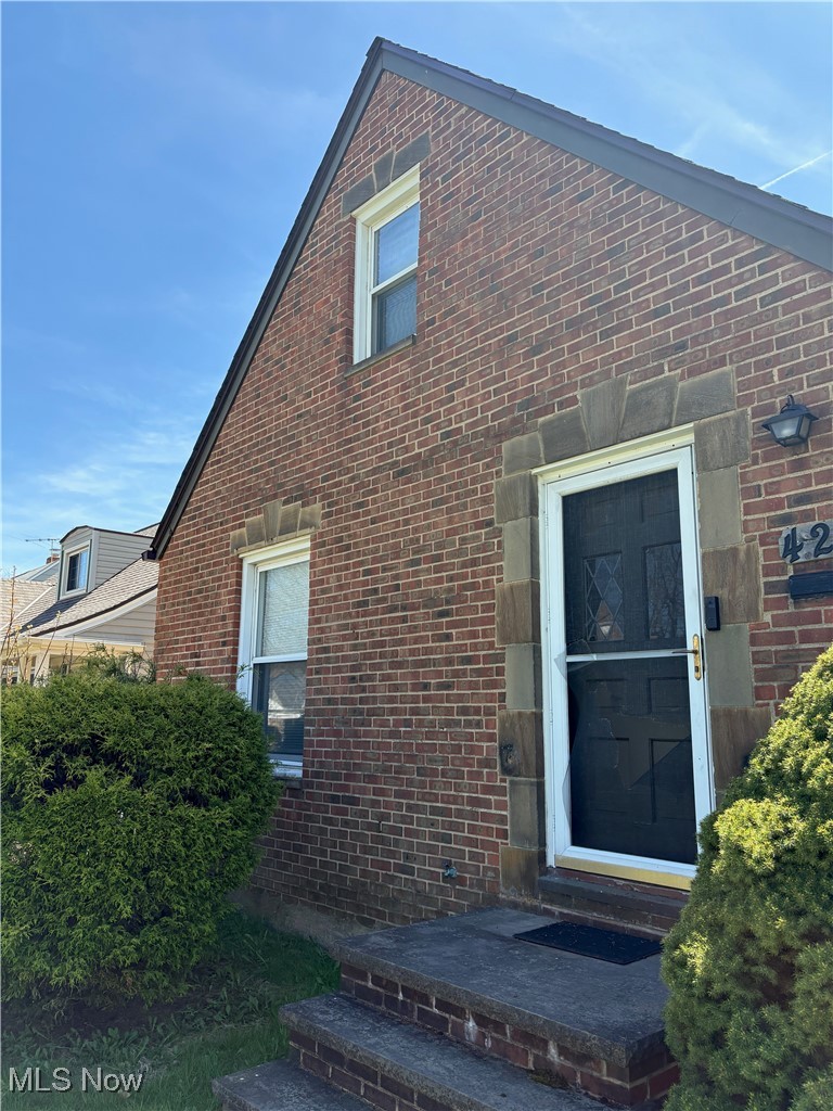 Property entrance with brick siding