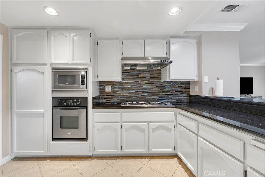 2611 Rudy Street Rowland Heights, CA 91748 - Photo 18 of 37 a kitchen with stainless steel appliances granite countertop a sink a stove and cabinets