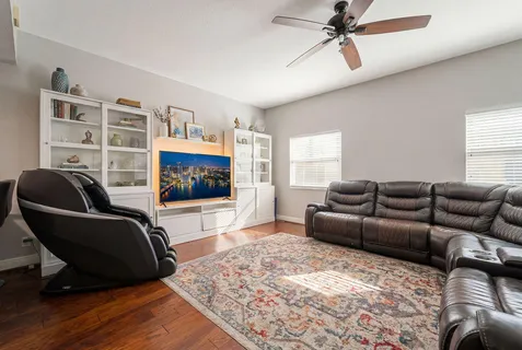 a living room with furniture and a flat screen tv