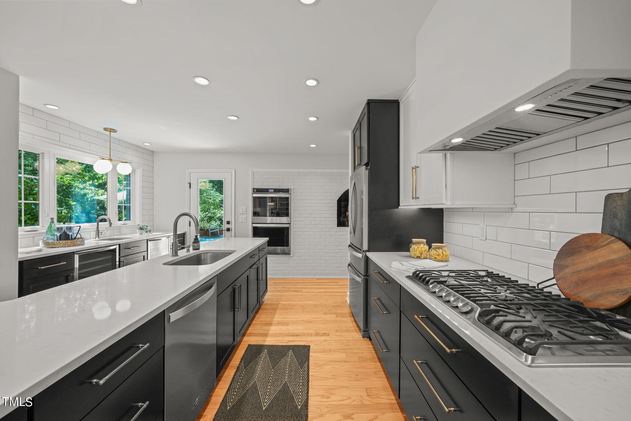 4604 Timberly Drive Durham, NC 27707 - Photo 11 of 60 a large kitchen with stainless steel appliances granite countertop a lot of counter space and a sink