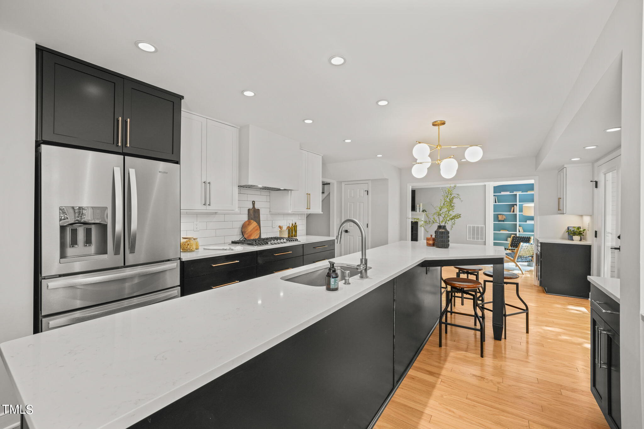 4604 Timberly Drive Durham, NC 27707 - Photo 14 of 60 a large kitchen with kitchen island a large counter top space a sink stainless steel appliances and cabinets