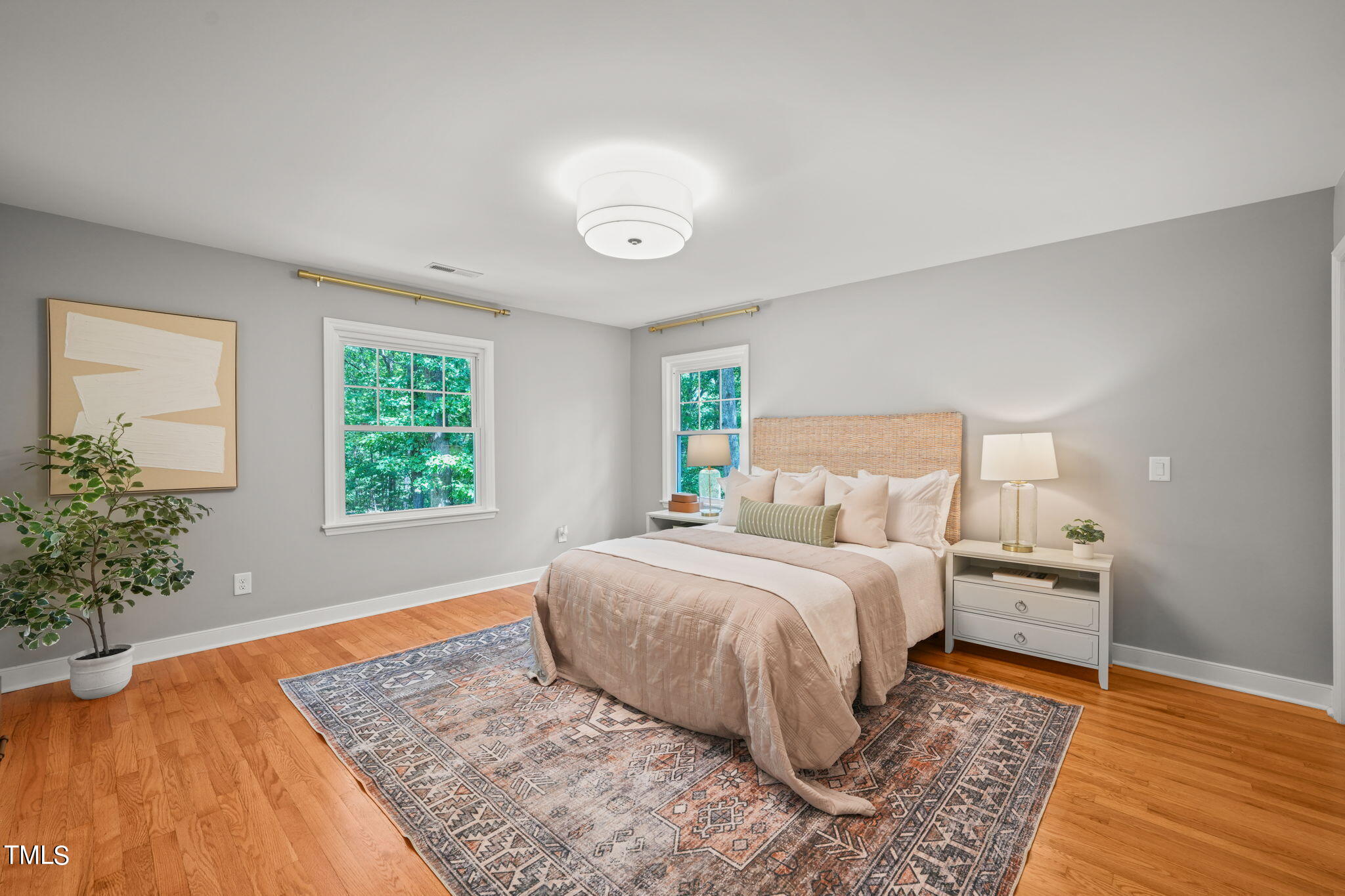 4604 Timberly Drive Durham, NC 27707 - Photo 26 of 60 a bedroom with a large bed and a potted plant
