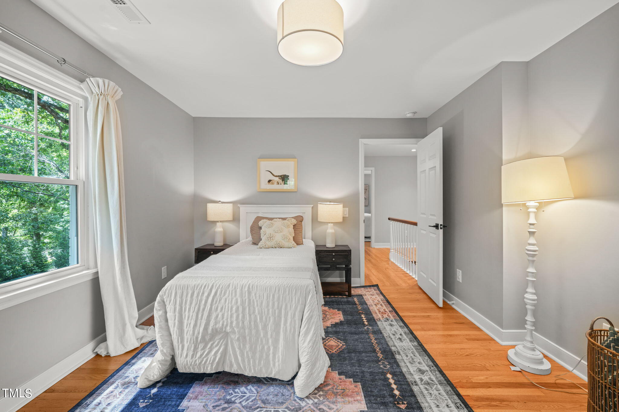 4604 Timberly Drive Durham, NC 27707 - Photo 31 of 60 a bedroom with a bed and wooden floor
