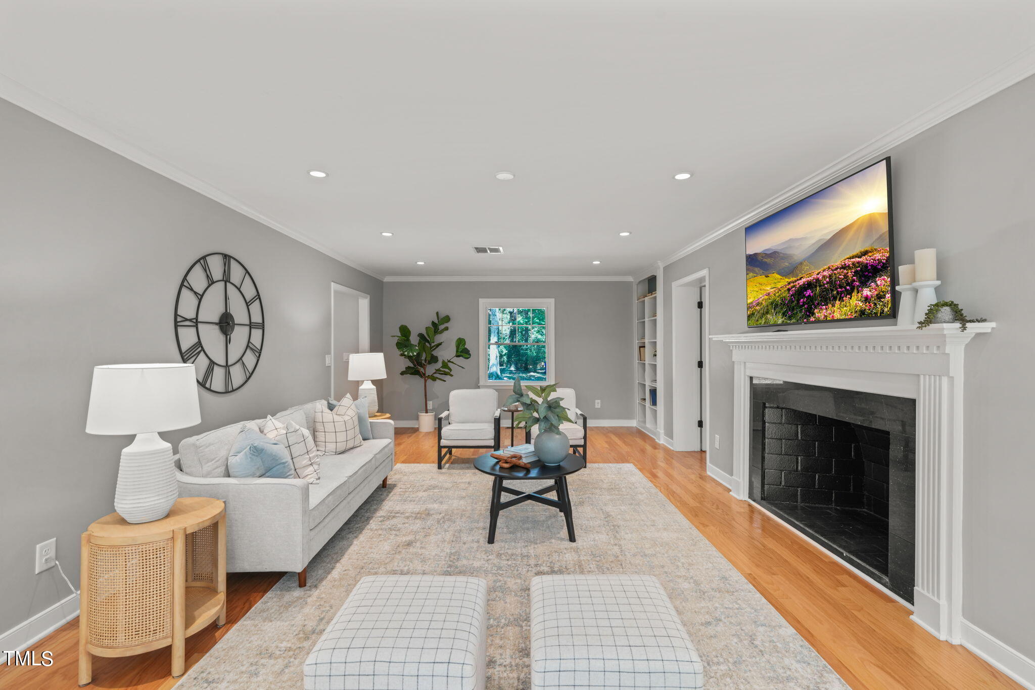 4604 Timberly Drive Durham, NC 27707 - Photo 8 of 60 a living room with furniture a fireplace and a flat screen tv