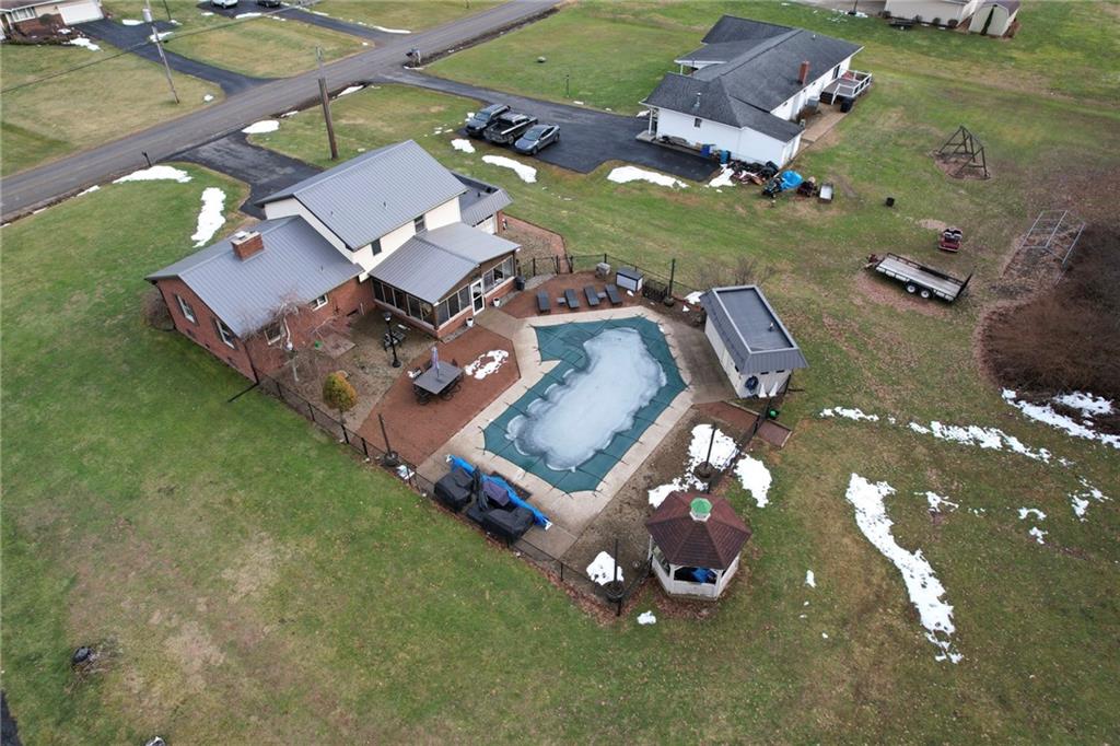942 Cleland Mill Road New Castle, PA 16102 - Photo 41 of 41 an aerial view of a house with a garden and parking spaces