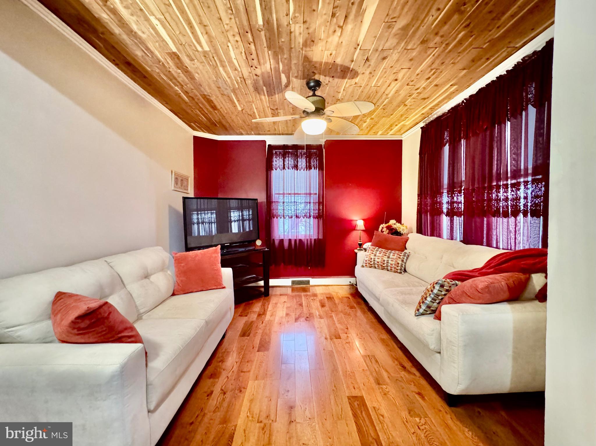 4428 Raspe Avenue Baltimore, MD 21206 - Photo 5 of 44 Large living room with wood floors and fireplace