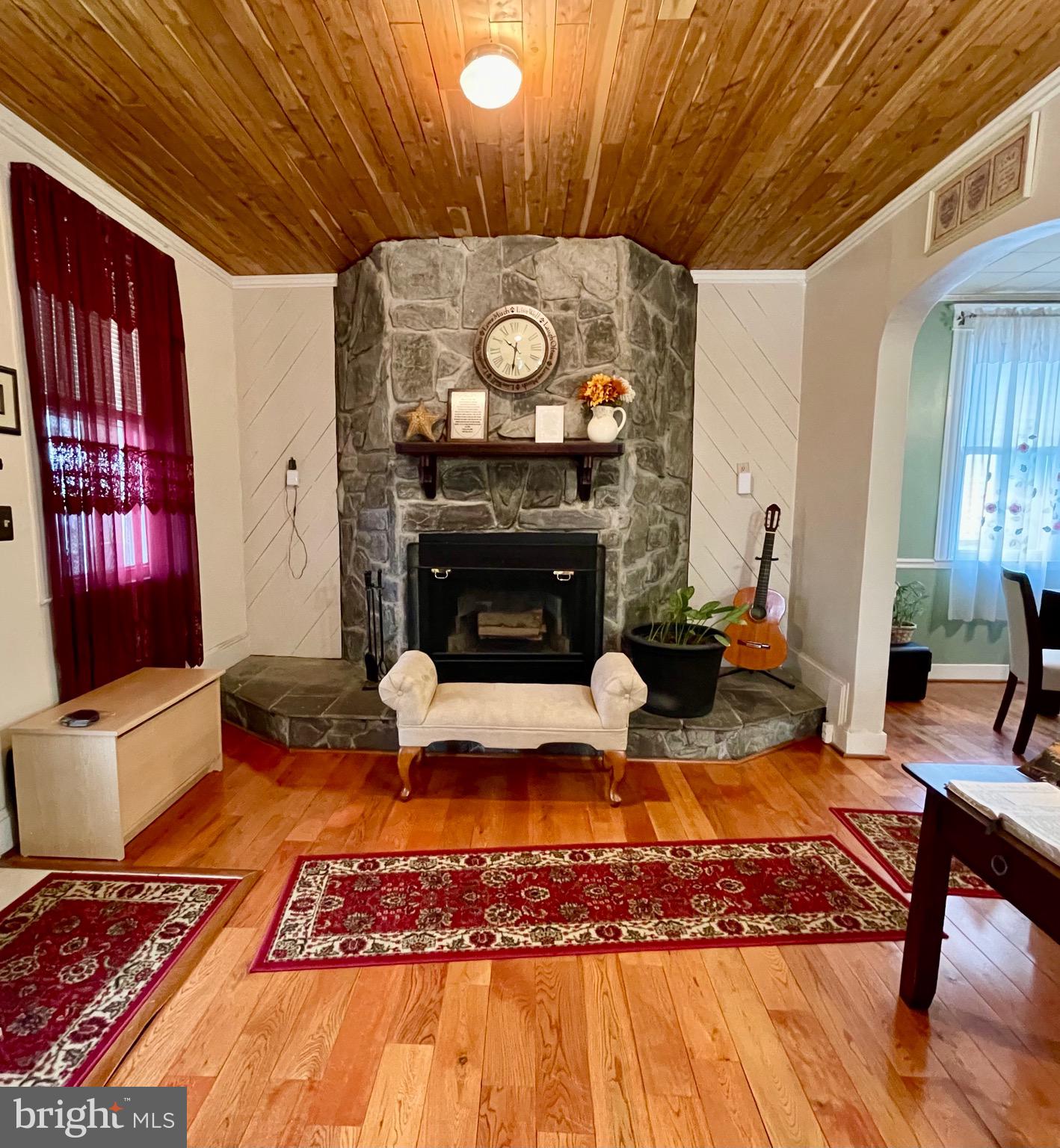 4428 Raspe Avenue Baltimore, MD 21206 - Photo 7 of 44 Large living room with wood floors and fireplace