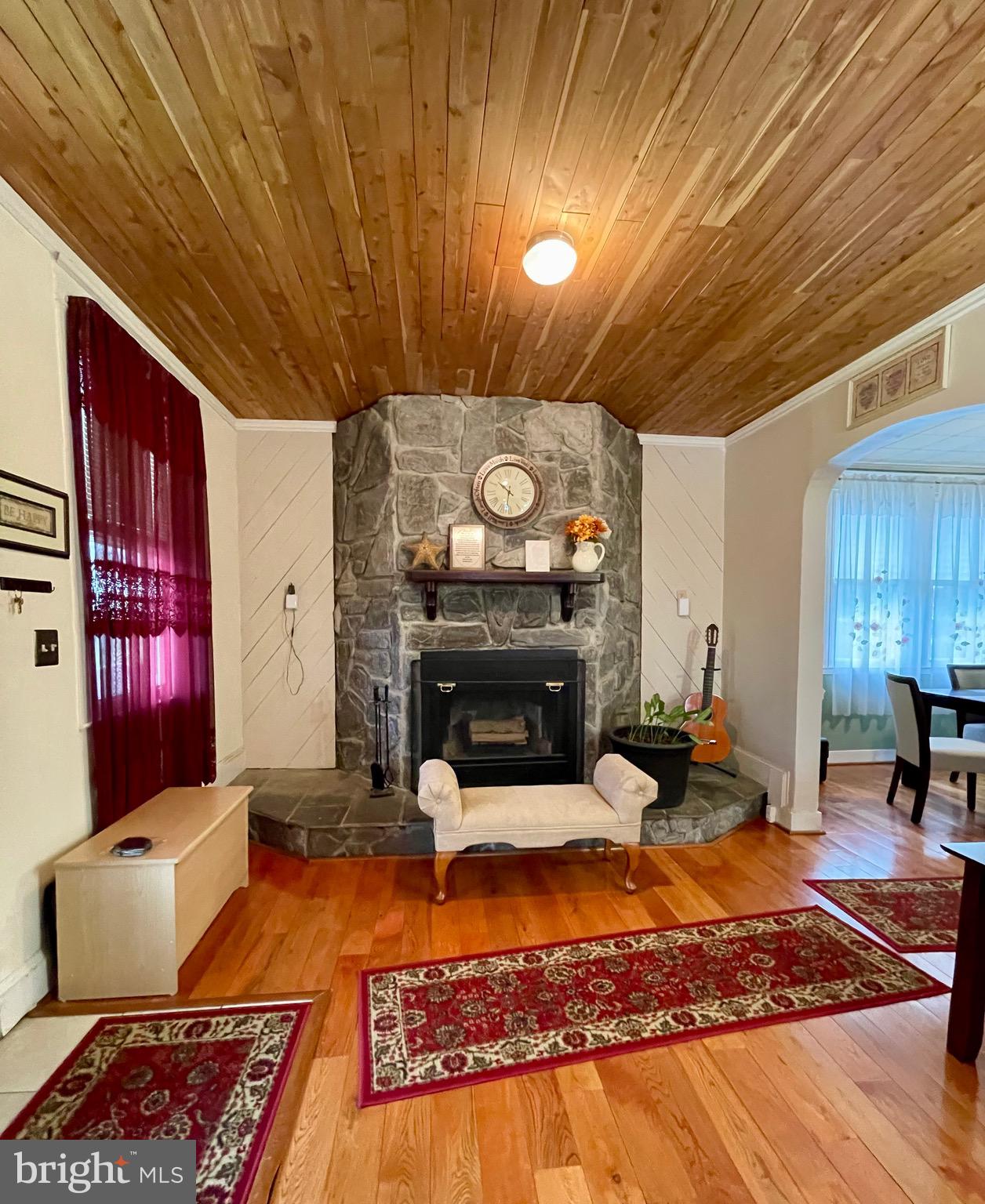 4428 Raspe Avenue Baltimore, MD 21206 - Photo 8 of 44 Large living room with wood floors and fireplace