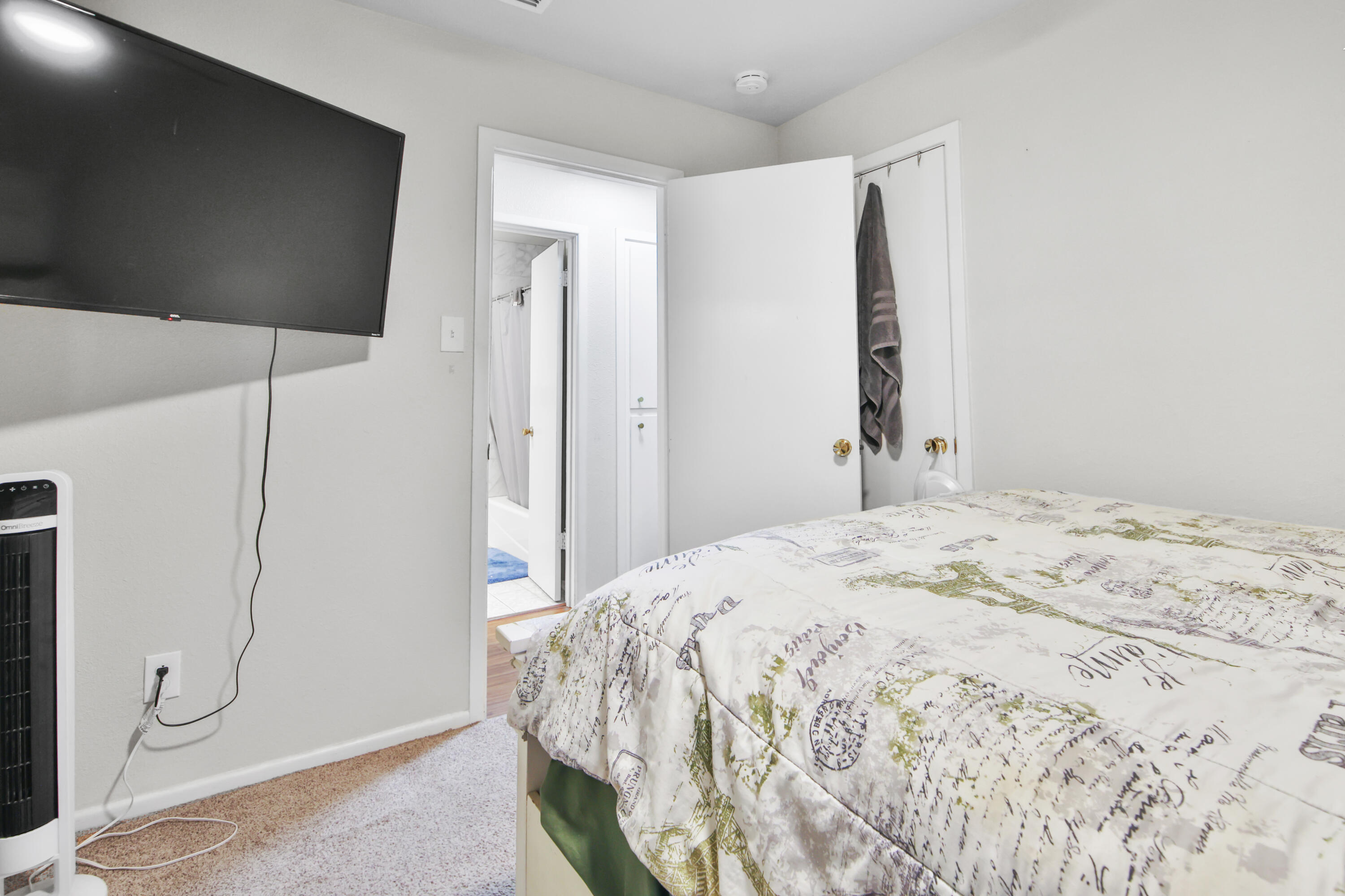 5625 Amherst Street Lubbock, TX 79416 - Photo 16 of 32 a bedroom with a bed and a flat screen tv